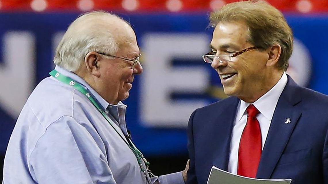 Sportscaster Verne Lundquist, left, greets Alabama head coach Nick Saban on Friday, a day before the SEC championship football game in Atlanta.