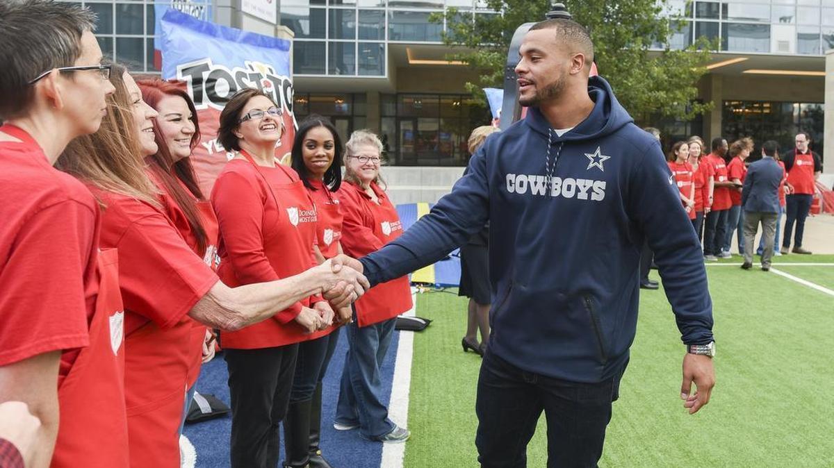Dallas Cowboys quarterback Dak Prescott greeted Salvation Army volunteers on Tuesday at The Star as part of a promotion.