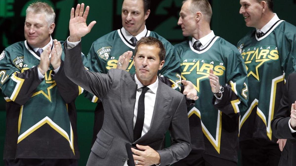 Former Dallas Stars player Mike Modano waves to the crowd during a jersey retirement ceremony in 2014.
