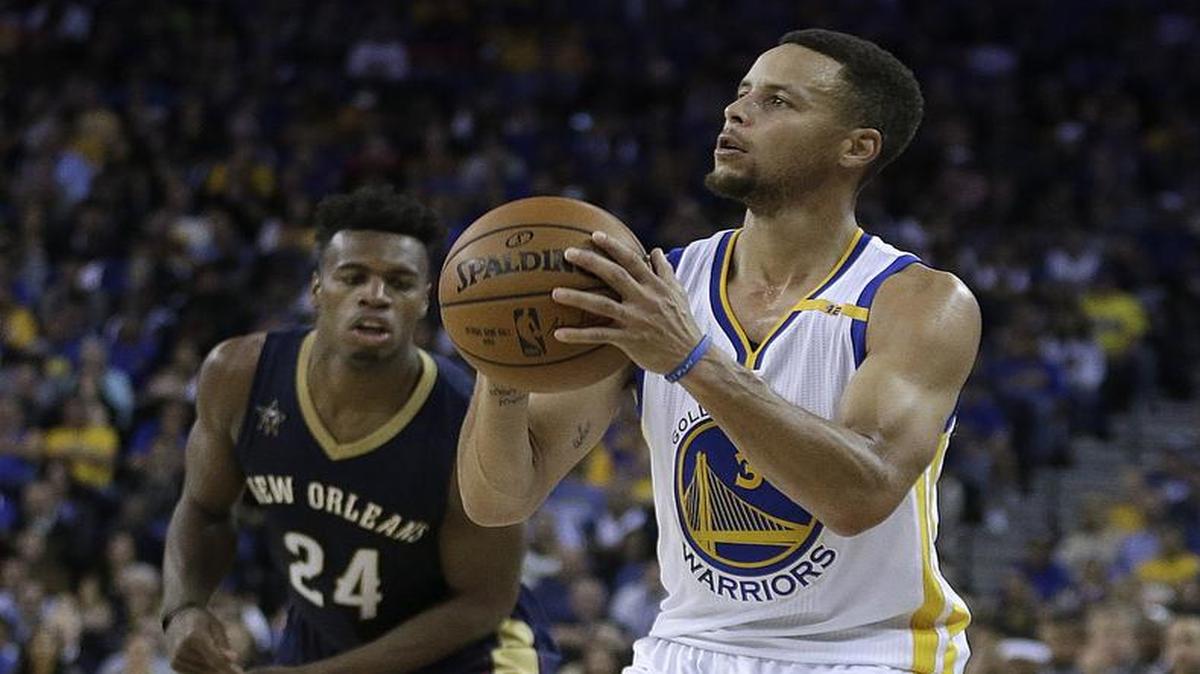 Golden State guard Stephen Curry, right, and the Warriors take on the Dallas Mavericks on Wednesday night in Oakland. Curry sank an NBA-record 13-pointers Monday and finished with a season-high 46 points in the Warriors’ 116-106 victory over New Orleans and Buddy Hield, left. Wednesday’s game will be televised at 9:30 p.m. on Fox Sports Southwest.