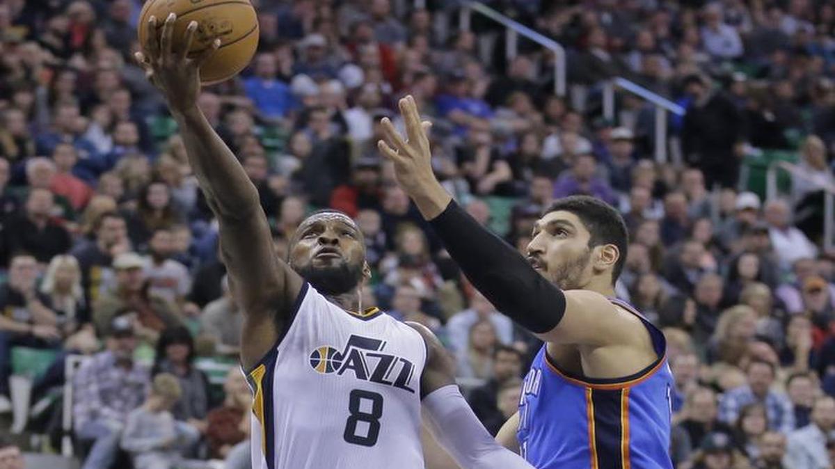 Shelvin Mack, left, drives past Oklahoma City Thunder Enes Kanter in Utah’s 109-98 victory Wednesday. The Jazz (16-10) play host to the Dallas Mavericks on Friday night. The game will be televised at 9:30 p.m. on FSSW and ESPN.