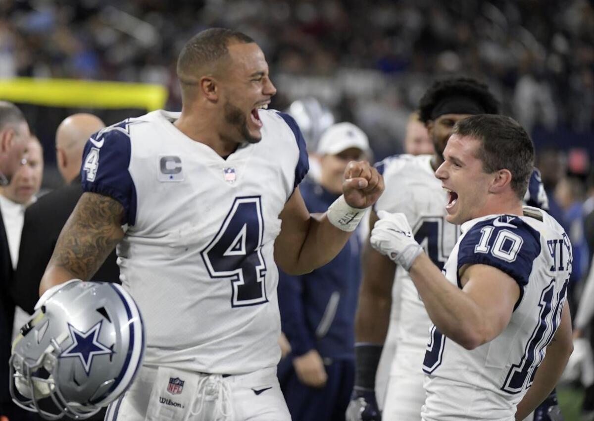 Dallas Cowboys quarterback Dak Prescott celebrates with wide receiver Ryan Switzer after Switzer's punt return for a touchdown.