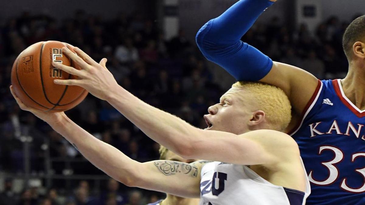 TCU guard Jaylen Fisher, takes a blow to the head from Kansas’ Landen Lucas as he drives to the basket in Friday’s Big 12 opener. The Horned Frogs, who lost 86-80, hope to deliver the final punch against Oklahoma on Tuesday at Schollmaier Arena. Tip-off is set for 8 p.m. on ESPNU.