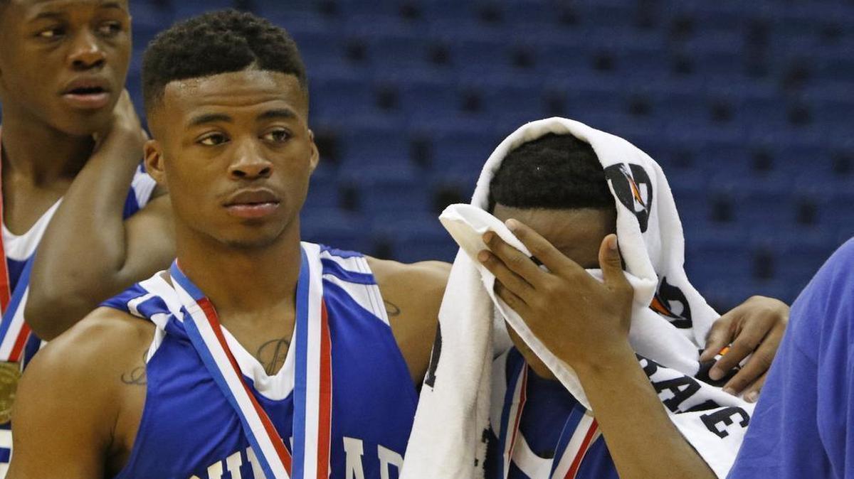 Fort Worth Dunbar’s Dewone Hayward, left, consoles teammate Jo’van after the loss to Fort Bend Elkins in the Class 5A boys state semifinals Thursday in San Antonio.