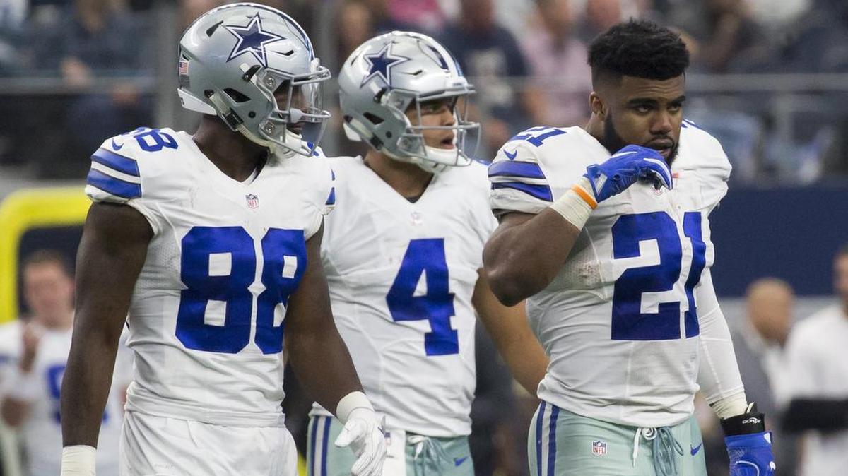 (l-r) Dallas Cowboys wide receiver Dez Bryant (88), quarterback Dak Prescott and running back Ezekiel Elliot walk back onto the field after a time out during a game against the Baltimore Ravens at AT&T Stadium, Sunday, November 20, 2016.