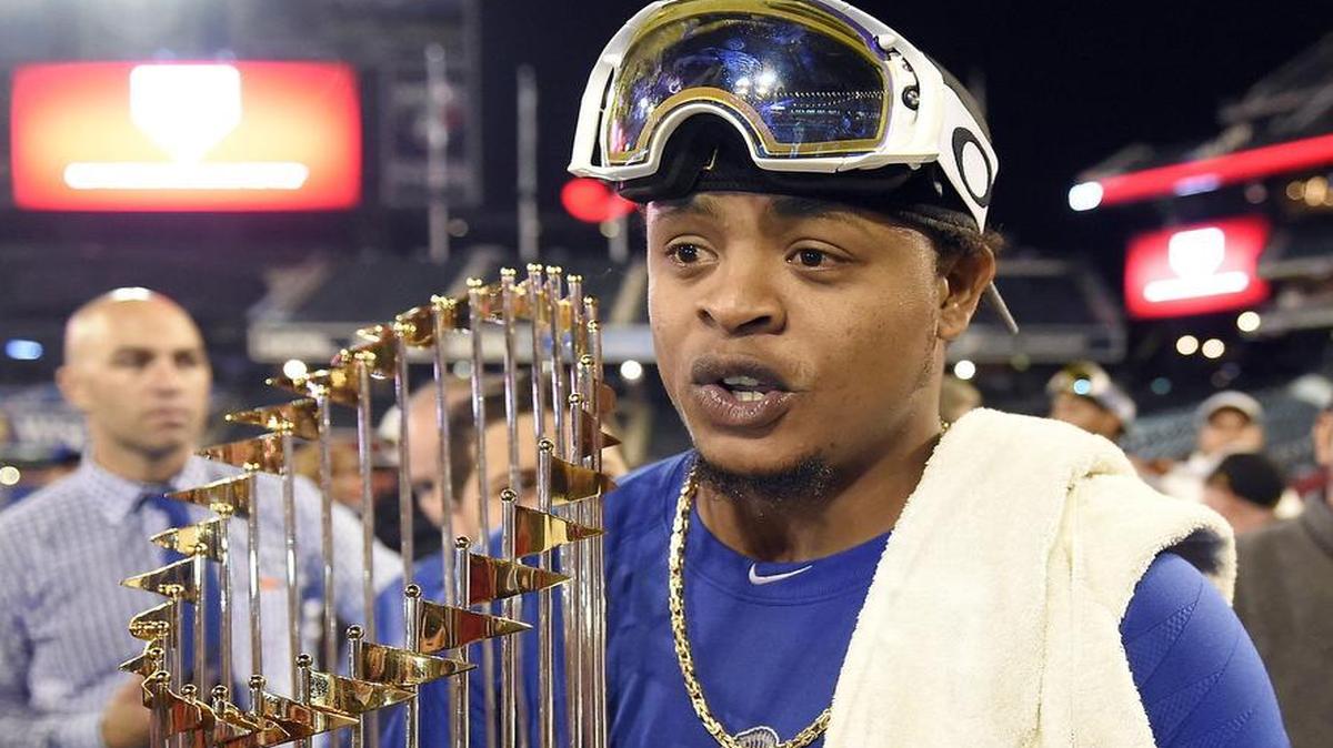 Kansas City Royals starting pitcher Edinson Volquez holds the World Series trophy after the Royals defeated the New York Mets 7-2 to win the title on Sunday, Nov. 1, 2015 at Citi Field in New York. The Royals will host the Mets at 7:30 p.m. Sunday in the final game of a tripleheader that begins with the Cardinals-Pirates at noon, followed by the Blue Jays-Rays at 3 p.m. on ESPN2.