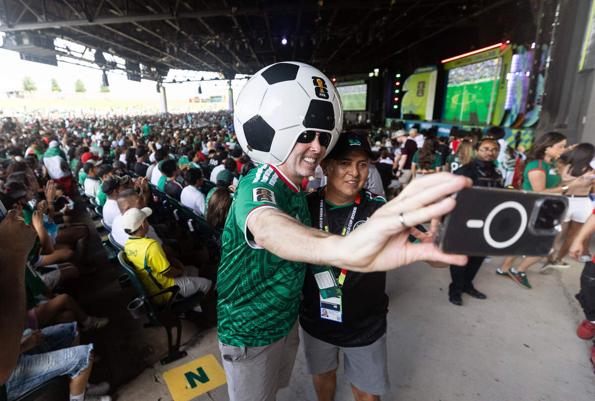 Gregg Wilson takes a selfie with Nava Carlos during the FIFA Fan Festival on Thursday, June 11, 2026, at Fair Park in Dallas. Wilson has been given the nickname "Wreckin' Ball" after attending numerous FIFA events while wearing his soccer ball helmet.